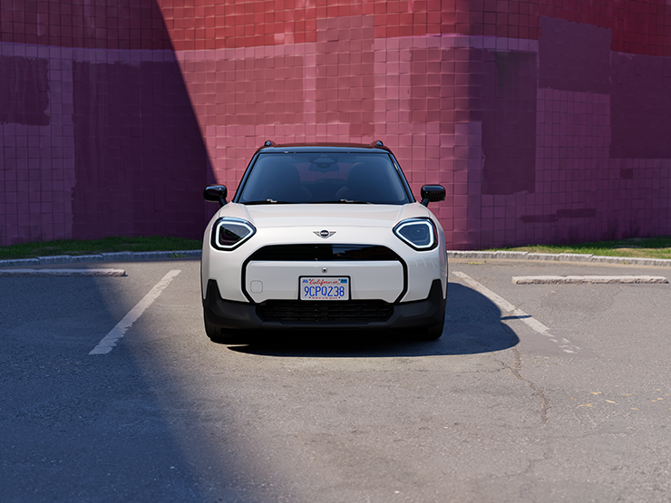 Front view of a MINI Countryman in Nanuq White Metallic parked in a marked parking space.