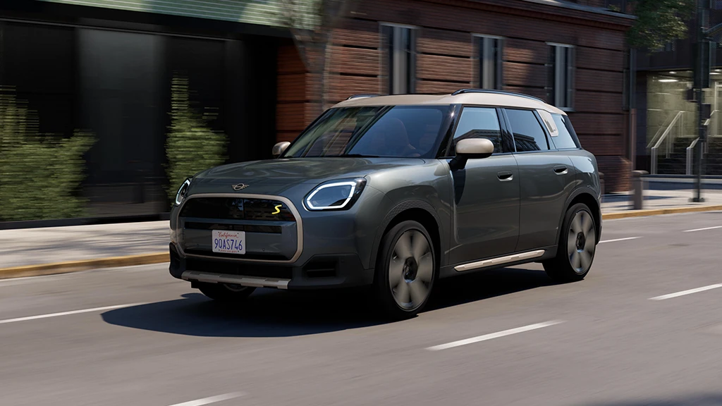All-electric MINI Countryman driving along an urban street.